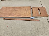 All desk components laid out: top, side panel, rail, hardware