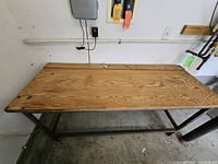 Top view of wooden workbench surface showing wear and chipping