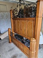 Headboard and footboard showing wood panels and iron scrollwork
