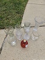 All eight glass items grouped on sidewalk