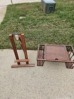 Easel and magazine rack together on pavement