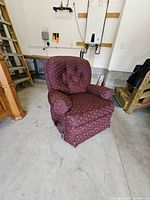 Front angled view of burgundy recliner showing upholstery and overall form