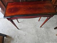 Top view of reddish-brown console table with black edge