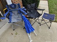 Group view of both chairs, folded umbrella, and side table
