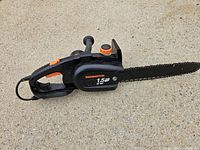 Left side view of Remington chainsaw showing bar, housing and branding