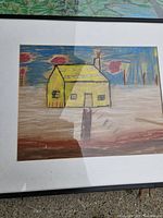 Yellow cottage drawing in frame