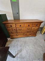 Front view of solid pine dresser with 12 drawers and metal bail pulls