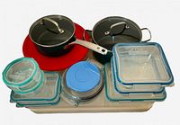 Overview of lot showing two Green Diamond saucepans with lids and multiple Snapware/Pyrex containers with lids