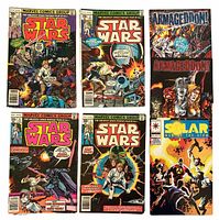 Seven comic books laid out: four Marvel Star Wars, two Armageddon, one Solar