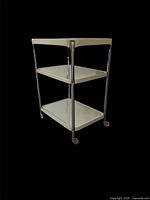 Perspective view of three-tier chrome and enamel Cosco cart
