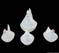 Front view of all four milk glass dishes, lids on