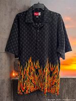 Front of black shirt with skull pattern and flame graphics