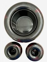 Top view of bowl and two candle holders showing interior shape and red accents