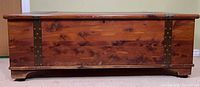 Front view of cedar chest closed showing wood grain and hardware