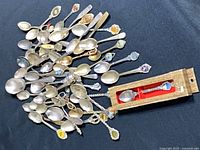 full lot of souvenir spoons spread out, boxed spoon included