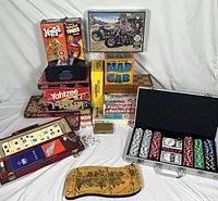 Overall lot view showing all boxed games, puzzle, poker set, tile rummy case and accessories