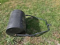 Overall view of lawn roller lying on grass