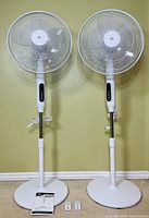 Two HOMCOM pedestal stand fans fully assembled, front view