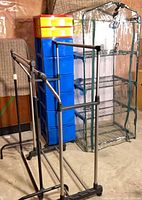 Indoor greenhouse, drawer unit, garment racks visible together