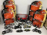 Group shot showing boxed Sons of Anarchy motorcycle, six Maisto Harley-Davidson blister packs and twelve loose die-cast bikes