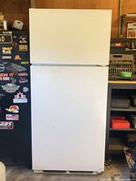 Front view of white Sears top-freezer refrigerator, closed