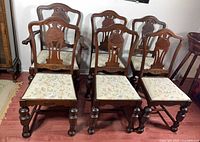 Front view of all six mahogany chairs showing design, upholstery and overall condition