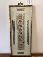 Full view of framed Chinese embroidered sleeve panel showing design, matting and frame