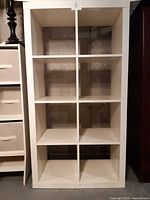 Full frontal view of white IKEA KALLAX 8-cubby shelf
