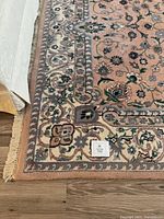 Corner of rug showing border, fringe and pattern