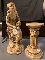 Girl statue and pedestal full view