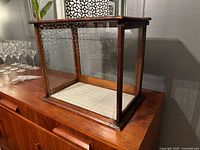 Front angled view showing wood frame and cracked glass pane