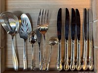 Close-up of selected serving pieces and knives