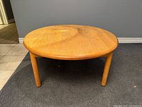 Full view of round oak coffee table front