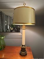 Full view of lamp on table showing shade, column, base