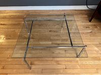 Full top view of square glass and chrome coffee table