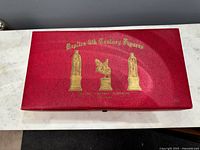 Red snap-close box with gold stamped 14th century figure images and Kingsway Florentine wording