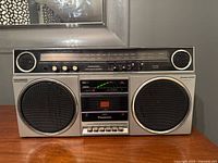 Front view showing full boombox, speakers, cassette deck and controls