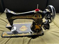 Full view of Butterfly sewing machine showing hand crank, decals, and overall condition