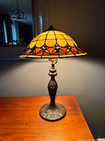 Lamp lit showing stained glass colors and metal base