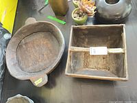 Top view of wooden oval bowl and square handled box