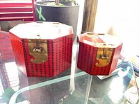 Both red lacquered octagonal boxes side by side