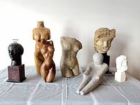 Group shot of all seven sculptures displayed on table
