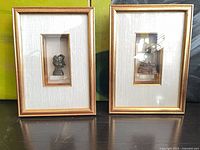 Front view of both framed figurines