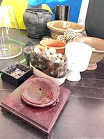 group view of assorted pots, stand, stones, decorative spheres