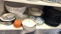 shelved lot showing variety of plates, bowls, casseroles