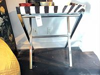 Front view of chrome X-frame side table showing mirrored tray top with zebra edge