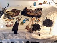 Entire lot on bed showing two throws and multiple curtain tiebacks