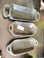 Three carved wood trays with handles