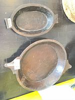 Two oval wooden trays, large and medium sizes