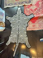 Full view of zebra-shaped rug on floor